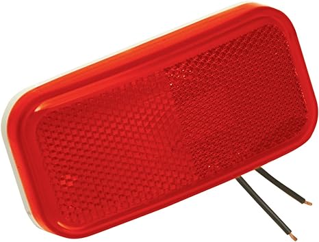 A red clearance light with mounting holes for vehicles.