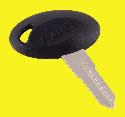 A black key blank with the brand name 'Bauer' embossed on it.