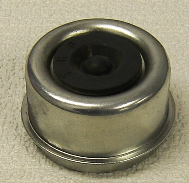 A silver metal dust cap for wheels.