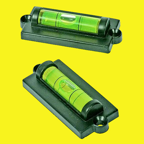Two black levels with bright green vials, shown from different angles on a yellow background.