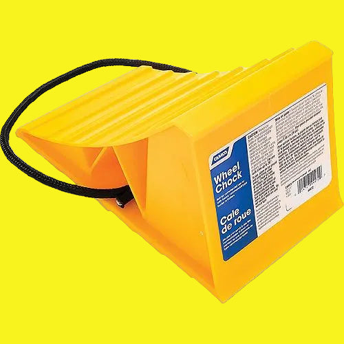 A single yellow wheel chock with a rope attached, designed for use on vehicle wheels.