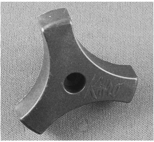 Black plastic window crank knob with a screw hole, on a textured background.