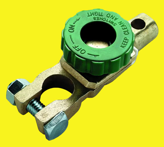 A green knob-operated battery disconnect with metal components and a rubber gasket.