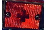 Red side marker lens with a cross design, mounted on a vehicle.