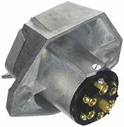 A silver metal trailer wiring connector with a 7-way round socket design.