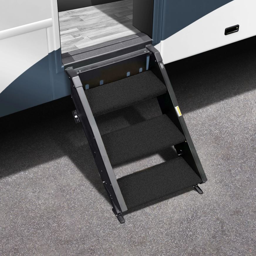 A set of black step rugs placed on black steps of a camper