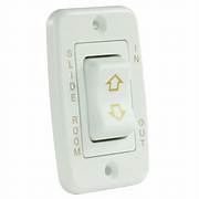 White electrical switch for camper slide-outs.