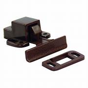 A concealed positive catch for cabinet doors, consisting of a dark brown rectangular component and a lighter brown mounting bracket with screw holes.