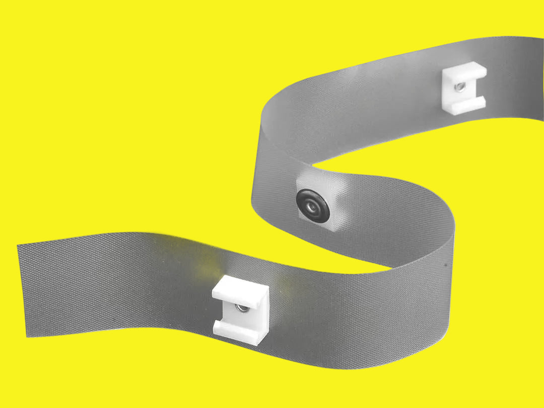 A length of white curtain glider tape with clip spacing, designed for use with ceiling or wall mount curtain tracks.
