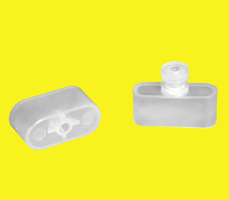 Two clear plastic end caps for RV window shades, with one showing the front view and the other the side view.