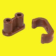 Two brown barrel catches with nylon clips for cabinet doors, set against a yellow background.