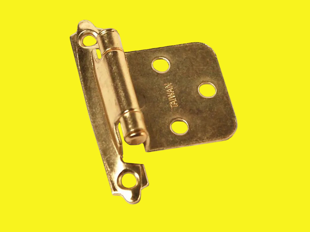 Self closing hinge with brass finish