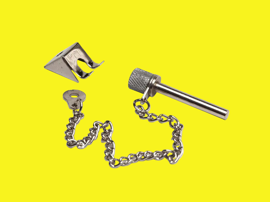 A refrigerator door lock consisting of a metal latch and a chain-linked mechanism, isolated on a yellow background.