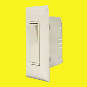 An ivory touch switch with a rocker switch mechanism, mounted on a white wall plate.