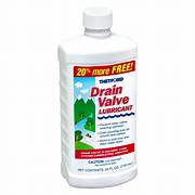 A 24 ounce bottle of Thetford Drain Valve Lubricant, with labeling that includes the product name.