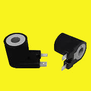 Two black gas valve solenoids on a yellow background