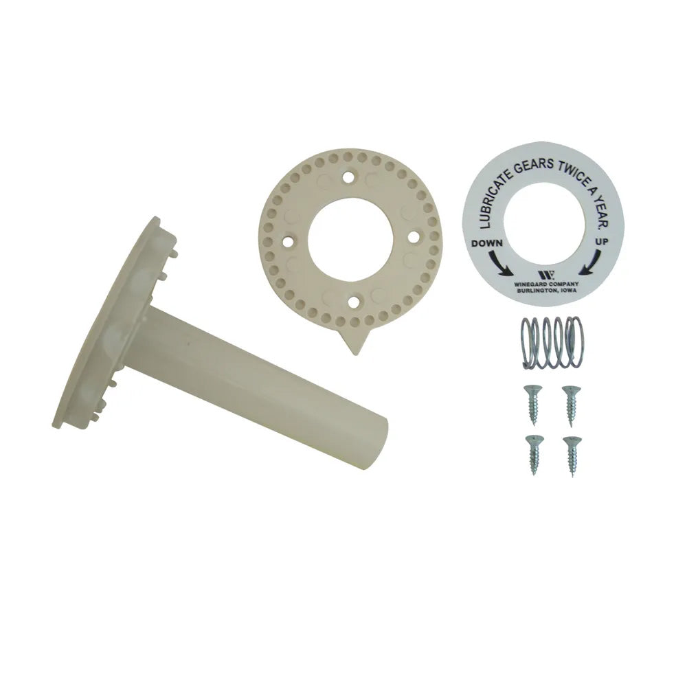 A set of antenna directional handle components including a round ivory piece with a central hole, a bar with a notch, four screws, a spring, and two decals.