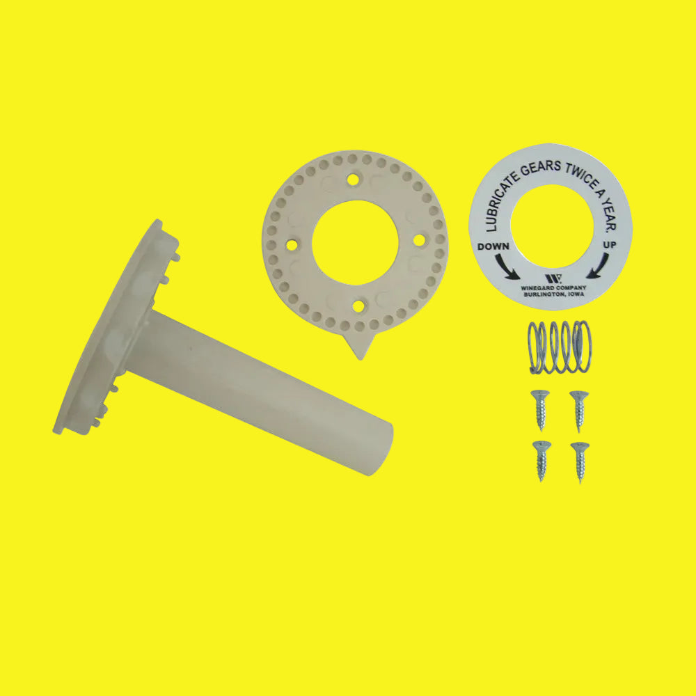 A set of antenna directional handle components including a round ivory piece with a central hole, a bar with a notch, four screws, a spring, and two decals.