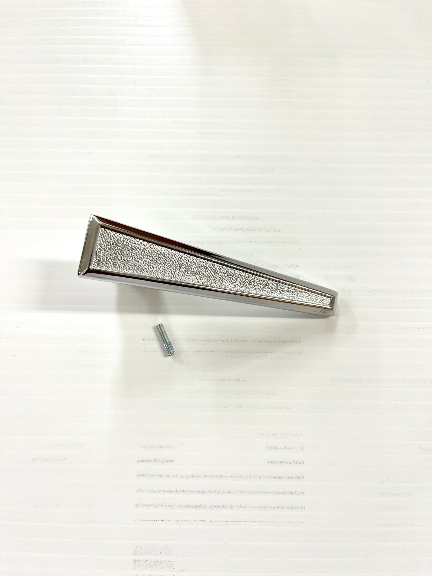 A chrome door latch/handle with a single design, placed on a white background.