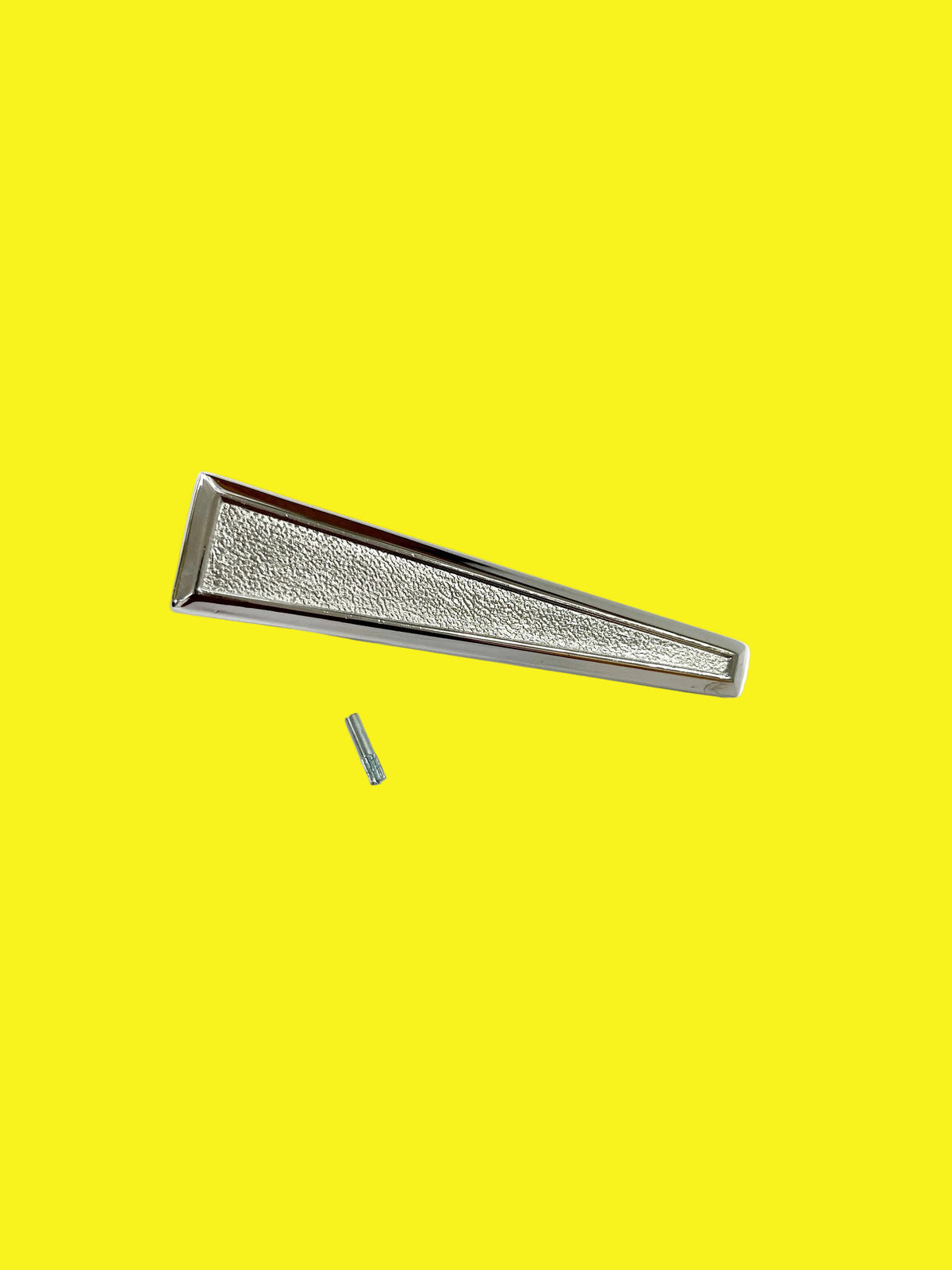 A chrome door latch/handle with a single design, placed on a yellow background.
