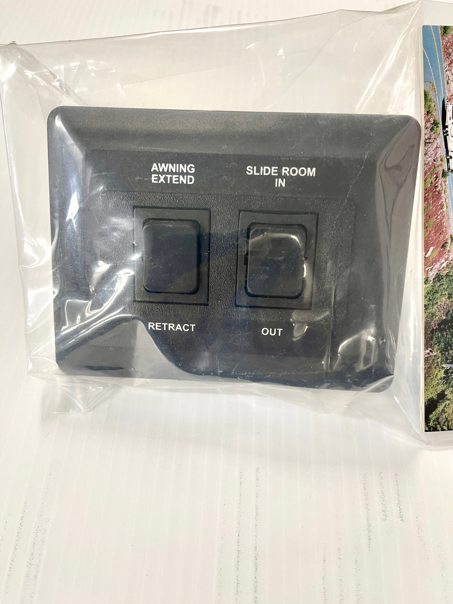 Contoured awning and slide-out switch, black