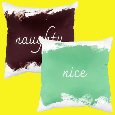 Two-sided pillow. One side maroon with white text, "naughty". The other side light green with white text, "nice"