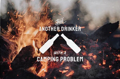 A rectangular throw blanket with a camping theme and a humorous text pattern that reads 'Another Drinker With A Camping Problem' along with a graphic of two bottles of beer at a campfire.