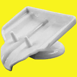A white plastic soap saver with a slanted design and plastic prongs.