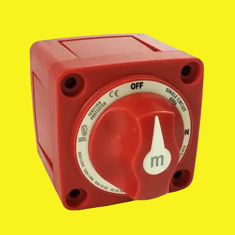 A red battery disconnect switch with a white circular dial on a yellow background.