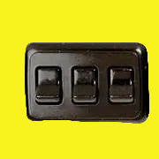A black multi-purpose switch with three rocker switches on a black panel.