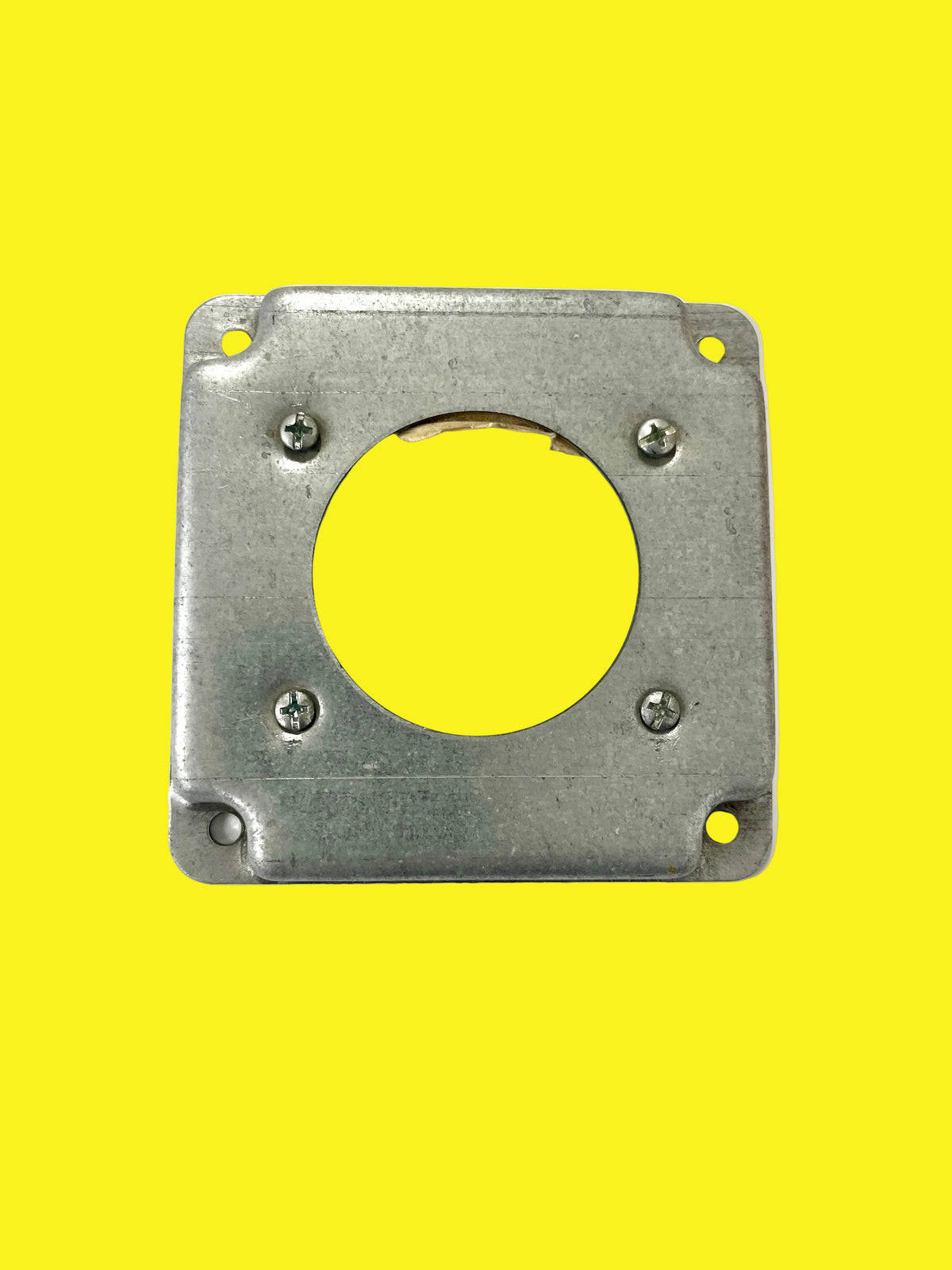 A square metal receptacle cover with a circle cutout in the center.