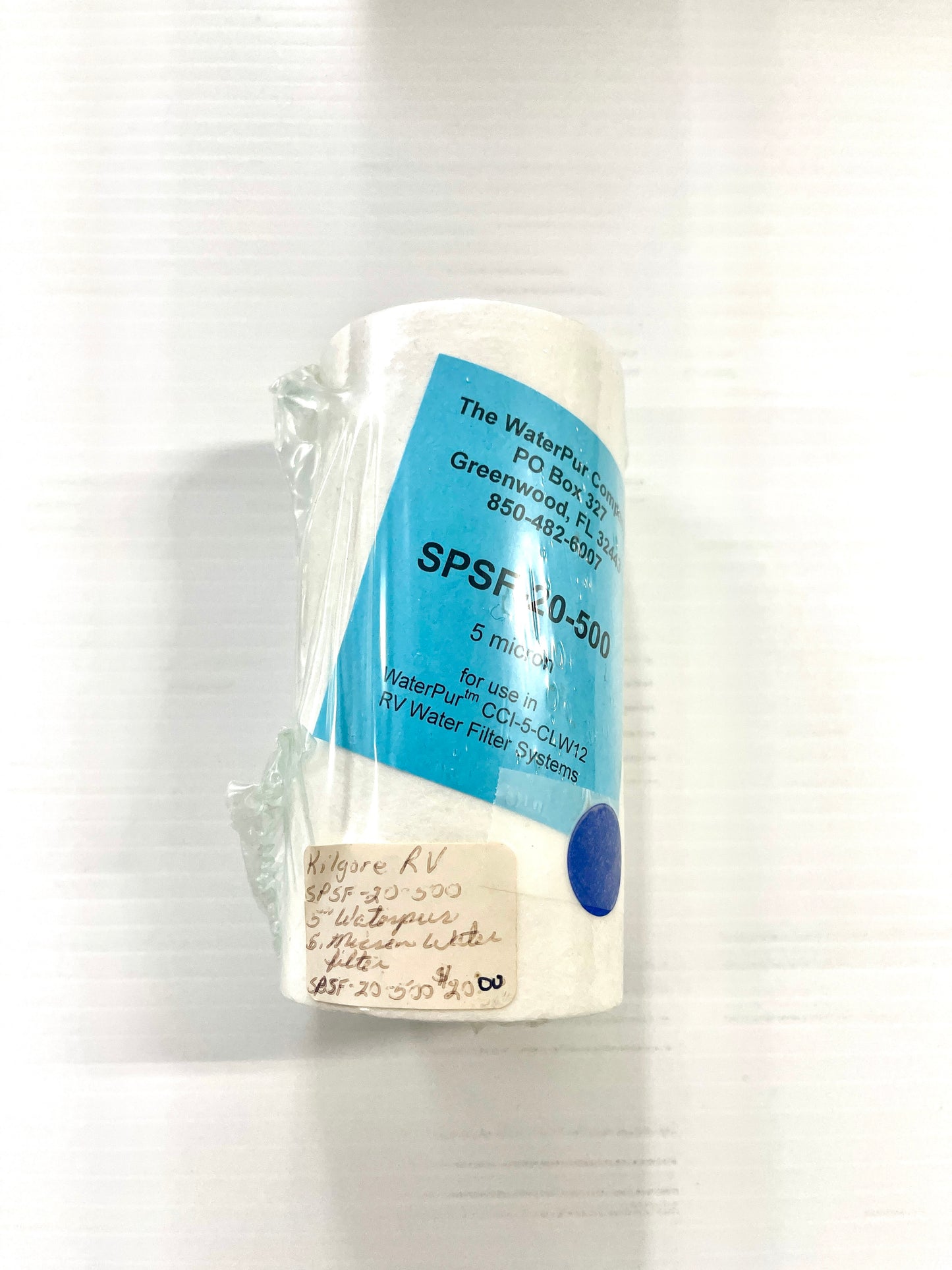 A white water filter with a blue label.