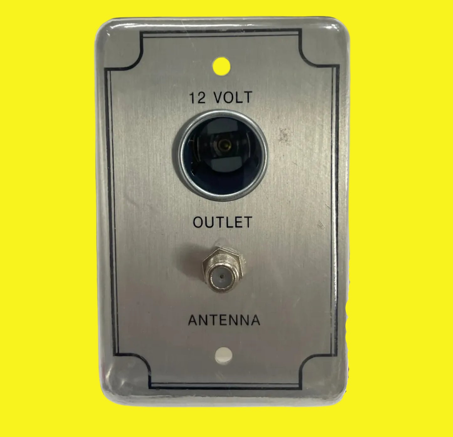 A 12-volt TV receptacle with a metallic silver finish, labeled 'ANTENNA' and 'OUTPUT',.