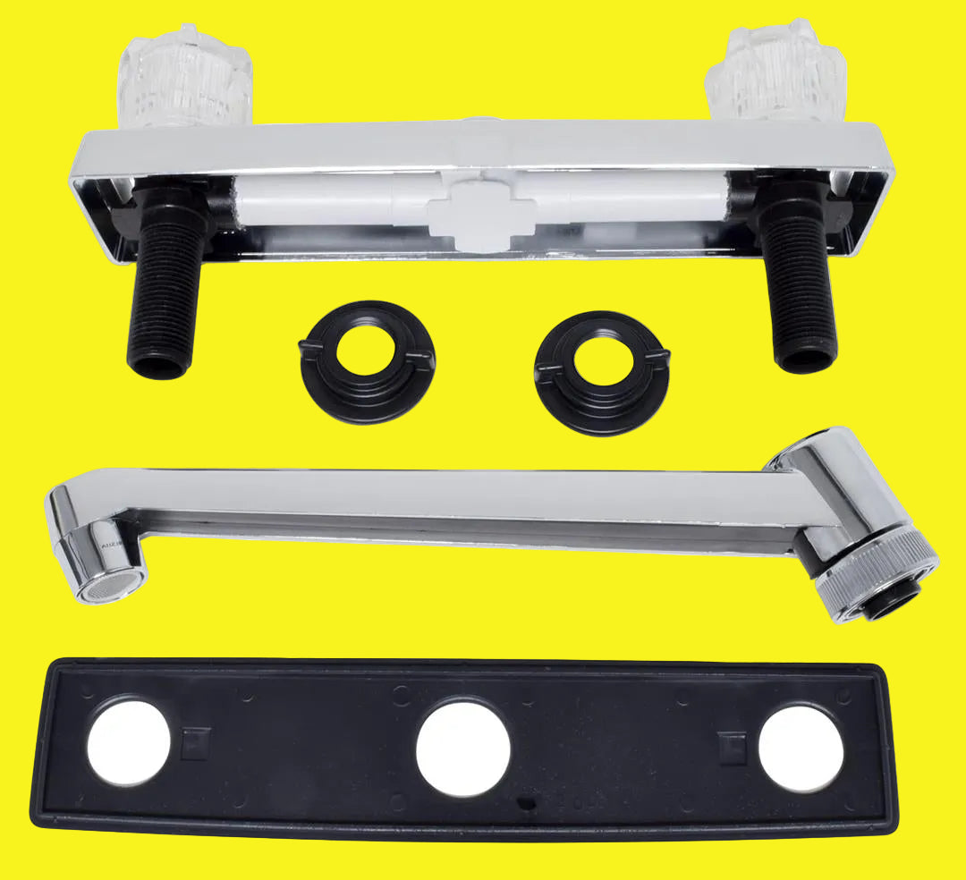 A set of kitchen faucet components laid out on a white background, including a chrome-plated bar deck mount, a D-shaped spout, two clear crystal acrylic knob handles, and a black plastic compression valve.