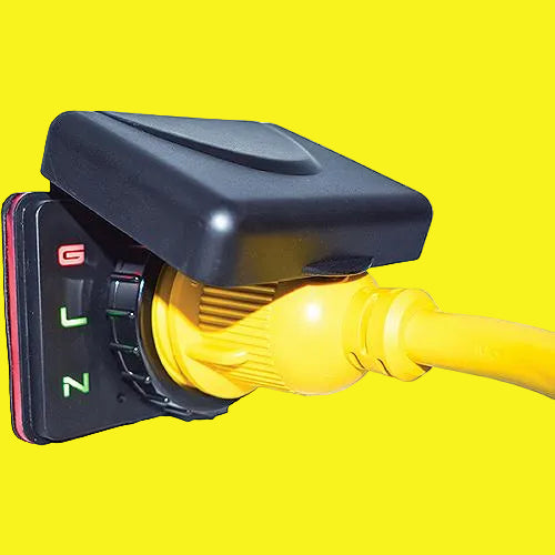 A close-up of a marine or outdoor electrical outlet with a black molded cover, a yellow connector plug, and a yellow cable running out of frame, shown on a yellow background.