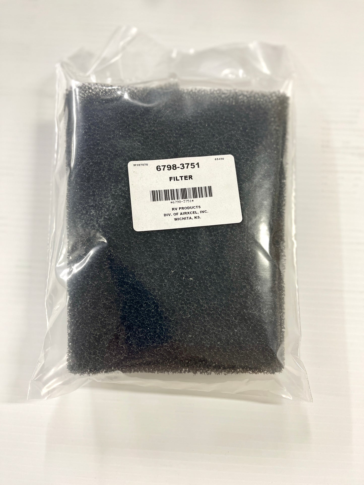 Coleman air conditioner filter in packaging, predominantly black in color with a label showing part number 6798-3751.