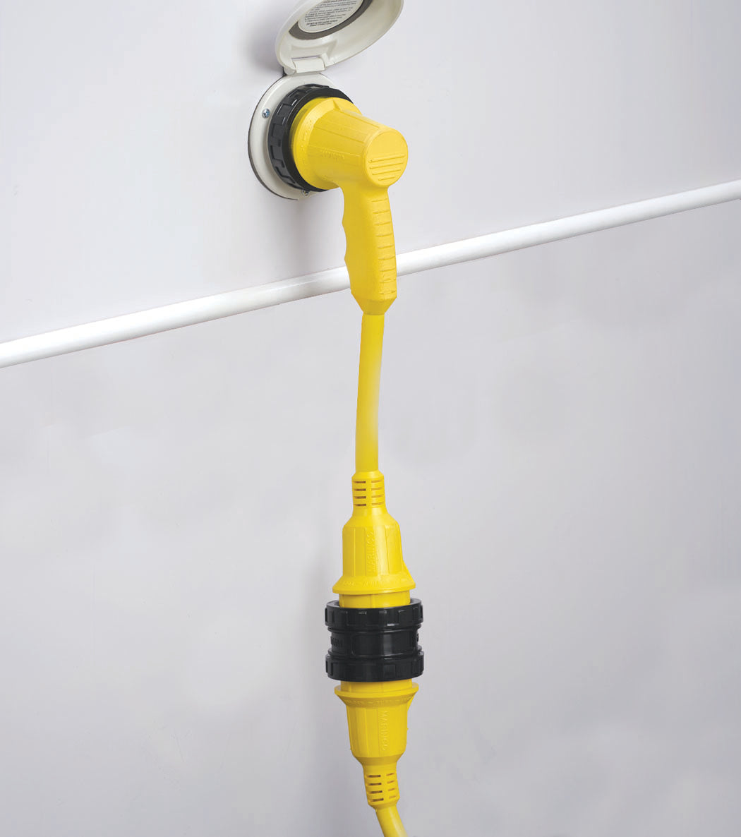 A yellow right angle adapter with a black handle and a white collar, plugged into a wall outlet.