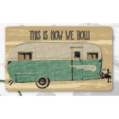 Accent rug with a vintage trailer design and the text 'This is how we roll' on it.