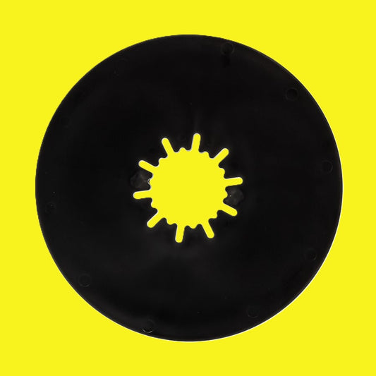 A circular black disc with a starburst-shaped cutout in the center, shown against a solid bright yellow background.