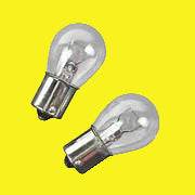 A clear incandescent light bulb with a metal base, showing the filament inside the bulb.