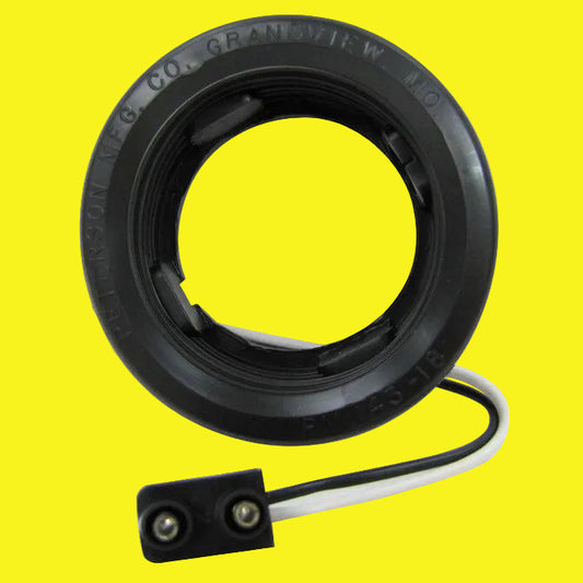 A black circular side marker grommet kit with black and white wires