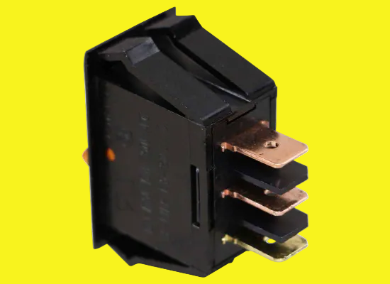 A black electrical switch with three terminals on a yellow background.