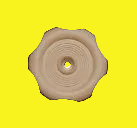 A single beige plastic flower-shaped cap or plug with a circular center hole, shown on a plain yellow background.