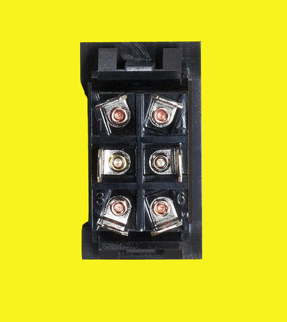 A black switch with six screw terminals, shown from a top-down view on a yellow background.