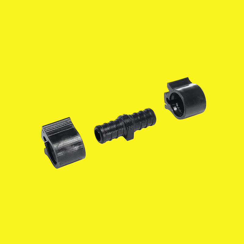A black coupling with two clamps on a yellow background