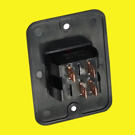 A black electrical switch  with four copper-colored terminals, mounted on a square black plastic base with screw holes, shown on a yellow background.