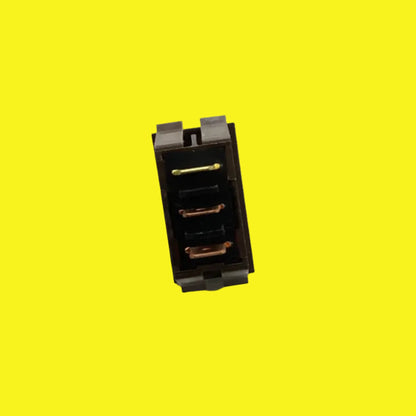 A brown electrical switch with copper-colored contacts on a yellow background.