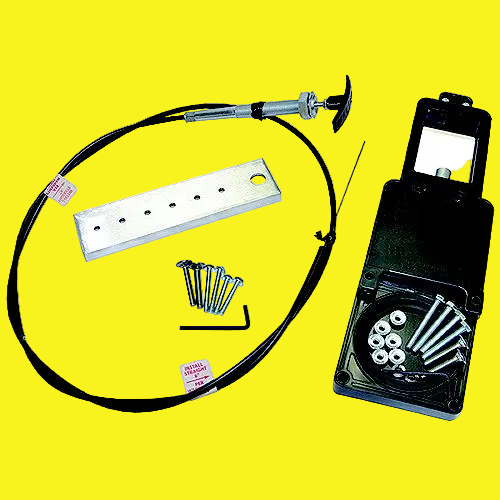 A mechanical cable assembly kit with a black cable, silver metal bracket, mounting screws, Allen wrench, and an open black plastic case containing hardware, shown on a yellow background.