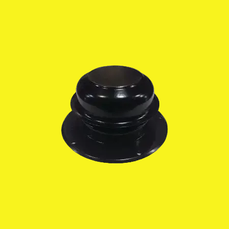 A black metal plumbing vent cap on a yellow background.