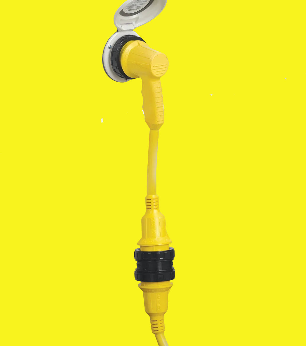 A yellow right angle adapter with a black handle and a white collar, plugged into a wall outlet.